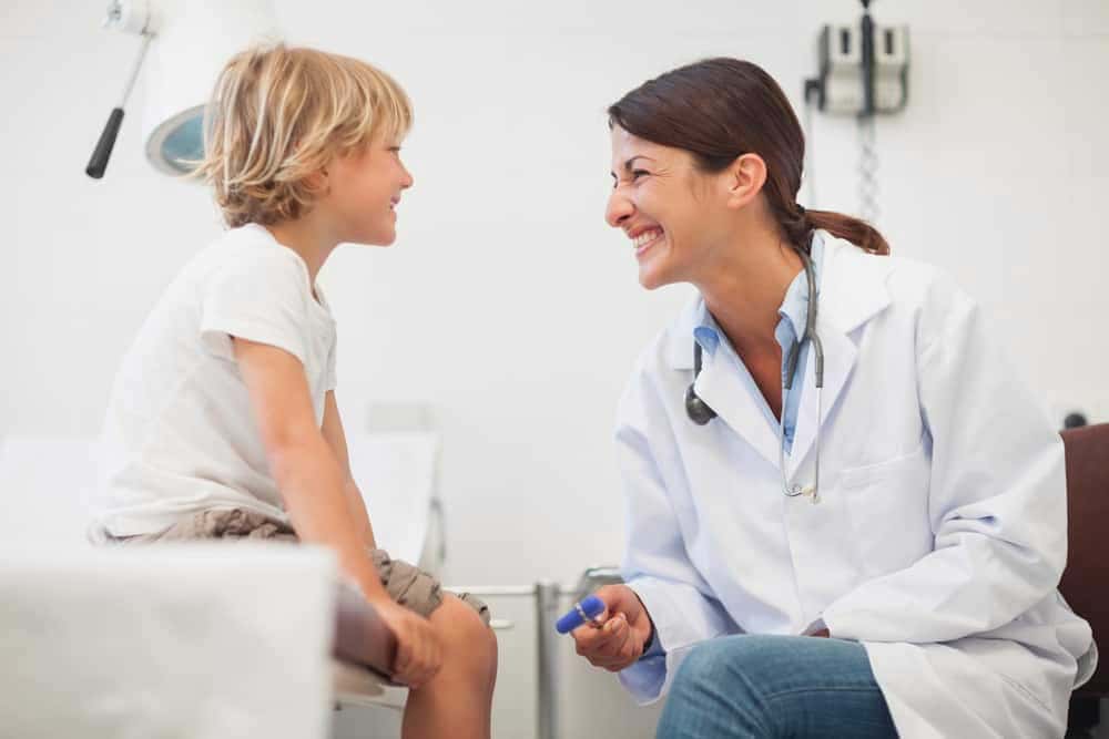 Image of Doctor Smiling to Child Examination Room